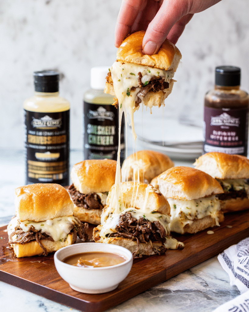 Chilly cheesesteak sliders served hot with cheese pull