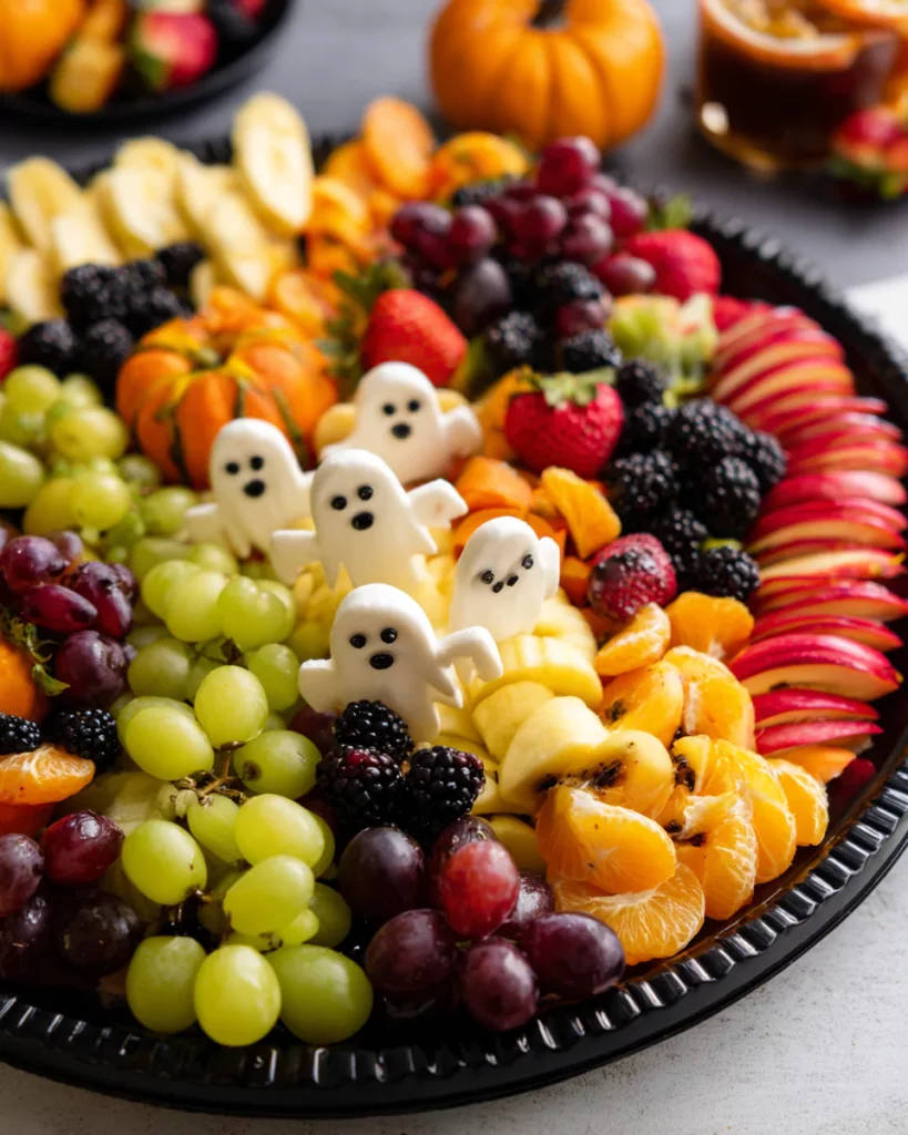 Assembling Halloween Fruit Salad platter